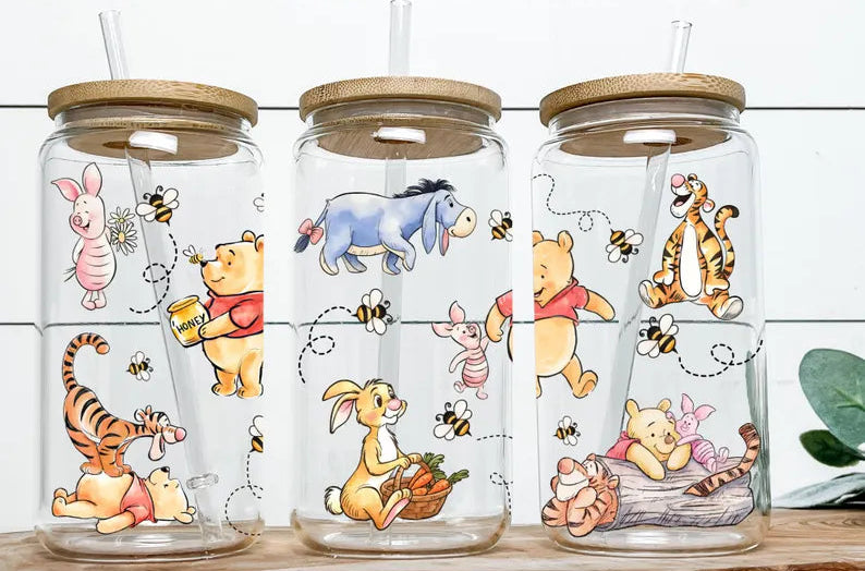 Three glass tumblers with Winnie the Pooh characters on a wooden surface, featuring Digital Barn Boutique branding.