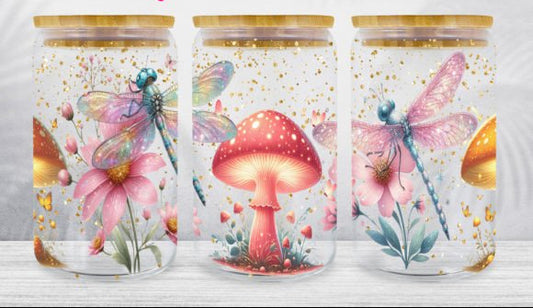 Three glass jars with artistic designs of mushrooms and dragonflies on a white background.